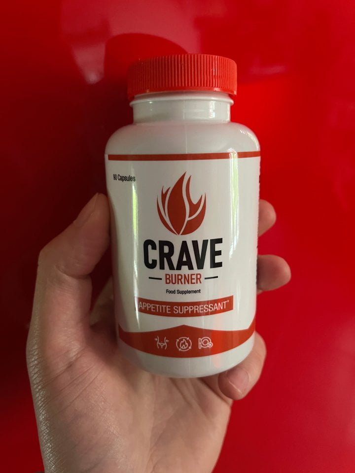 Crave Burner 14 hand holds a bottle of pills.