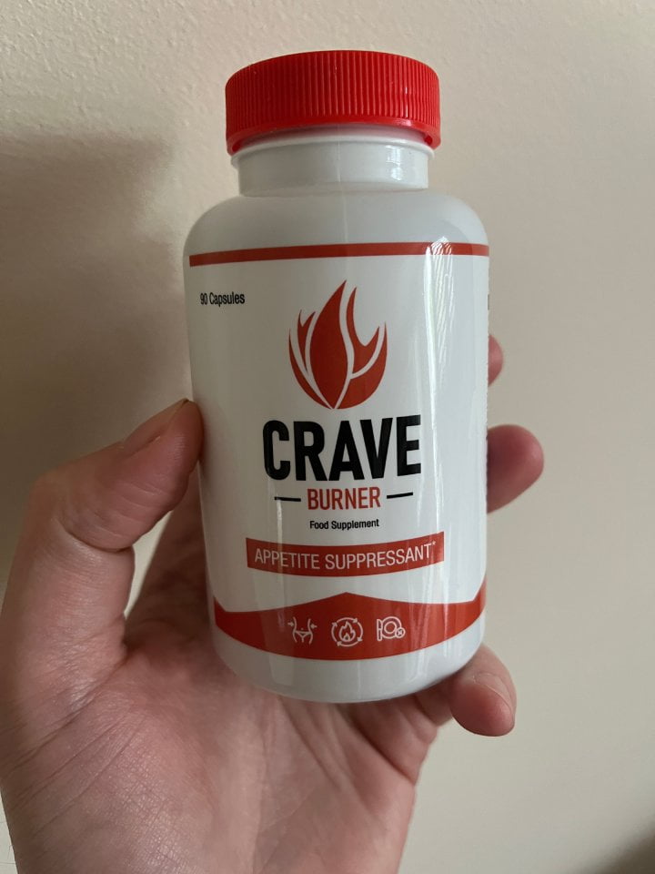 Crave Burner 12 hand holds a bottle of pills.