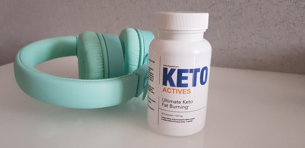 Keto Actives 18 white pill box and bottle with blue letters, along with blue headphones.