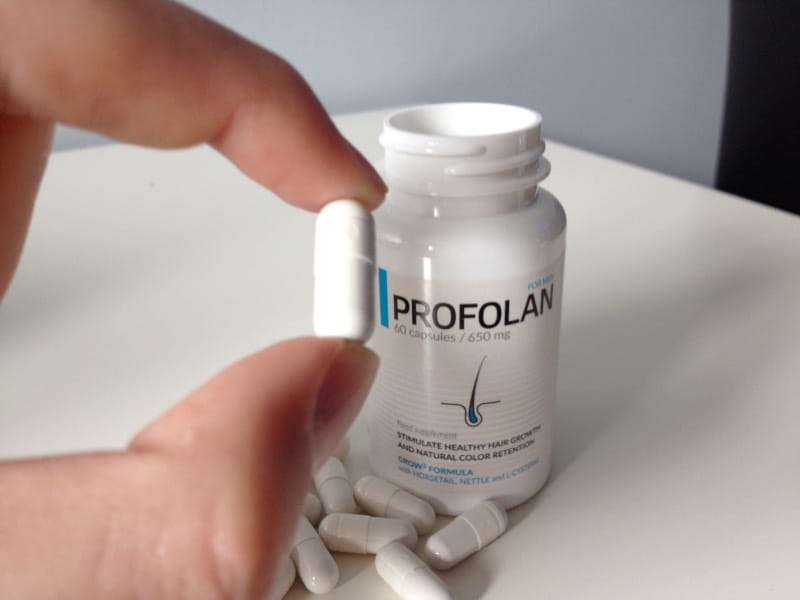 Profolan 5 hands hold a pills.
