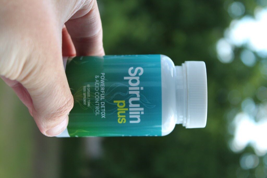 Spirulin Plus 12 bottle white green medicine and white and yellow letters