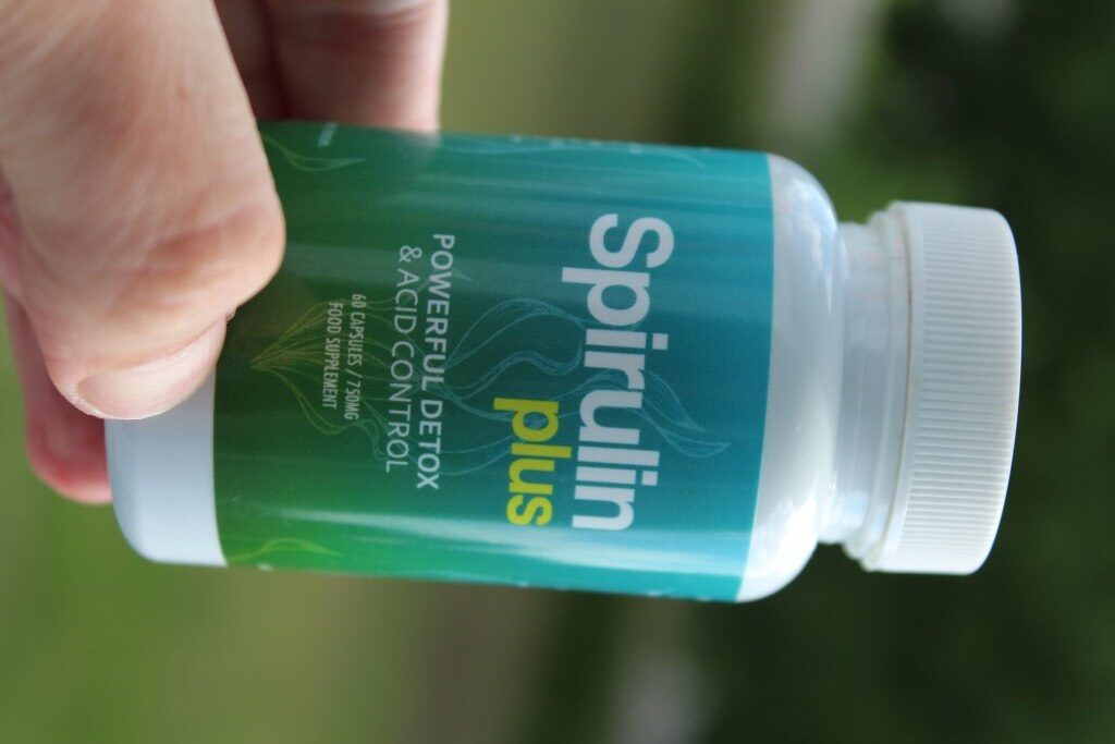 Spirulin Plus 13 bottle white green medicine and white and yellow letters